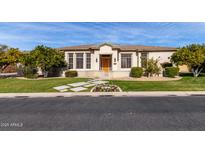 One-story home with landscaped yard and walkway at 3326 E Ivyglen Cir, Mesa, AZ 85213