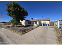 Ranch style home with a large front yard and mature tree at 4411 N 56Th Dr, Phoenix, AZ 85031