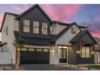 Striking two-story home boasts modern farmhouse design with black trim and a three-car garage at 4420 E Glenrosa Ave, Phoenix, AZ 85018