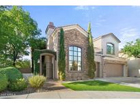 Stunning two-story home with stone accents and lush landscaping at 5019 E Lucia Dr, Cave Creek, AZ 85331