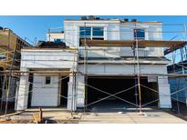 New home construction features a modern design with an attached garage, framed windows and stacked roofing tiles at 5132 E Umber Rd, San Tan Valley, AZ 85143