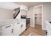 Modern kitchen features white cabinets, stainless steel appliances, and quartz countertops at 5855 N 48Th Ave, Glendale, AZ 85301