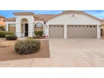 Single-story home with two-car garage and desert landscaping at 747 E Nolan Pl, Chandler, AZ 85249