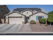 One-story home with solar panels, attached garage, and landscaped yard at 7934 W Andrea Dr, Peoria, AZ 85383