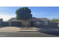 Single-story home with attached garage and landscaped front yard at 8651 W Glenrosa Ave, Phoenix, AZ 85037