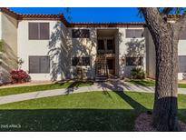 Attractive exterior of a condo building with landscaping and walkway at 9990 N Scottsdale Rd # 2048, Paradise Valley, AZ 85253