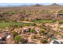 Expansive desert home on a golf course with scenic mountain views in a lush, landscaped setting at 10420 E Morning Vista Ln, Scottsdale, AZ 85262