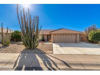 Tan house with cacti and a two-car garage at 11035 E Nopal Ave, Mesa, AZ 85209