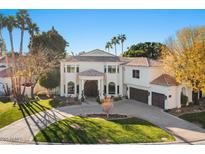 Elegant two-story home with circular driveway and lush landscaping at 1519 E Treasure Cove Dr, Gilbert, AZ 85234