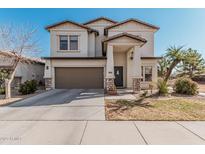 Two-story house with attached garage and landscaped front yard at 16705 N 175Th Dr, Surprise, AZ 85388