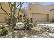 Desert landscape accents this contemporary home's exterior, featuring a private gated entry and two-car garage at 17025 E La Montana Dr # 130, Fountain Hills, AZ 85268