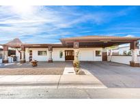 Single-story home with carport, landscaped yard, and decorative pillars at 1707 W Wayland Rd, Phoenix, AZ 85041