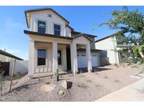Attractive two-story home showcasing a welcoming front porch with sturdy columns and a well-maintained front yard at 1932 W Rowel Rd, Phoenix, AZ 85085