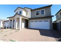 Charming two-story home featuring a two-car garage and a welcoming covered entryway with substantial pillars at 1932 W Rowel Rd, Phoenix, AZ 85085