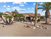 Single-story home with desert landscaping and a two-car garage at 20215 N 149Th Dr, Sun City West, AZ 85375