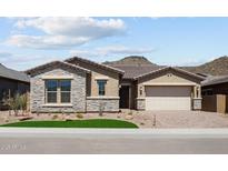 Inviting single-story home featuring stone accents, a tiled roof, and desert landscaping at 32470 N 134Th Ln, Peoria, AZ 85383