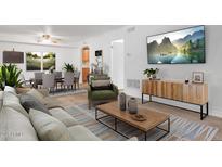 Open concept living room boasts modern furniture, hardwood floors and a large flat screen television at 3825 E Camelback Rd # 239, Phoenix, AZ 85018