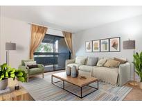 Bright living room with large sliding doors to balcony allowing for plenty of natural light at 3825 E Camelback Rd # 239, Phoenix, AZ 85018