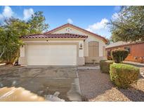 House exterior featuring a two-car garage and well-maintained landscaping at 45513 W Sky Ln, Maricopa, AZ 85139