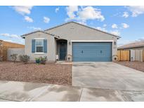 One-story home with gray siding, blue garage door, and landscaped front yard at 4887 N 179Th Dr, Goodyear, AZ 85395