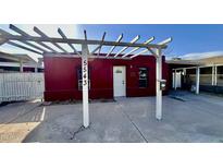 Charming red house with white pergola and address number 5543 at 5543 W Gardenia Ave, Glendale, AZ 85301
