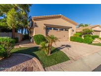 Single-story home with tan exterior, two-car garage, and landscaped front yard at 6202 E Mckellips Rd # 42, Mesa, AZ 85215