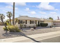 Single story home with landscaped front yard and two-car garage at 10631 W Brookside Dr, Sun City, AZ 85351