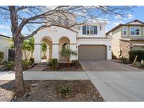 Two-story house with arched entryway and attached garage at 10713 E Hawk Ave, Mesa, AZ 85212