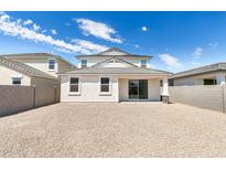 Large gravel backyard with a two-story house and block wall at 17826 W Sanna St, Waddell, AZ 85355