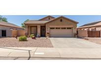 Single-story house with a two-car garage and landscaped front yard at 1825 N Lewis Pl, Casa Grande, AZ 85122