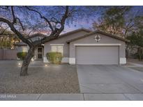 Charming single-story home featuring a well-manicured front yard and a two-car garage at 2171 S Portland Ave, Gilbert, AZ 85295