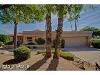 Tan single story home with mature landscaping and a two car garage at 25609 N Forest Rd # 20, Rio Verde, AZ 85263