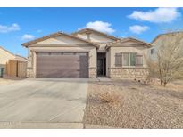 Single-story home with a two-car garage and desert landscaping at 2562 N Abbey Rd, Casa Grande, AZ 85122