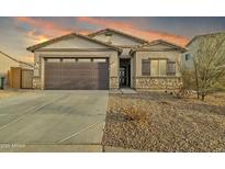 Single-story home with a two-car garage and desert landscaping at 2562 N Abbey Rd, Casa Grande, AZ 85122