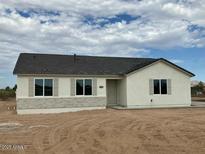 One-story home with neutral exterior, dark roof, and stone accents at 25835 W Denver Hills Dr, Wittmann, AZ 85361