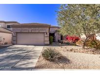 Single-story home with desert landscaping and a two-car garage at 26818 N 66Th Ln, Phoenix, AZ 85083