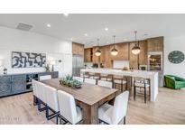 Open kitchen features a large island, custom cabinetry, and breakfast area at 40715 N Lytham Ct, Anthem, AZ 85086