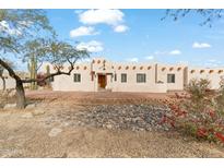 Spanish-style home with stucco exterior, multiple windows, and a landscaped front yard at 7110 W Villa Lindo Dr, Peoria, AZ 85383