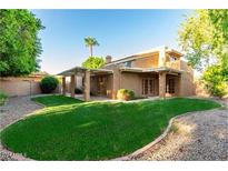 Large backyard with grassy lawn and covered patio area at 921 E Becker Ln, Phoenix, AZ 85020