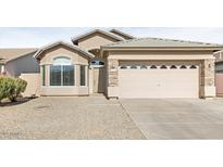 One-story house with a two-car garage and neutral-colored exterior at 11702 W Madison St, Avondale, AZ 85323
