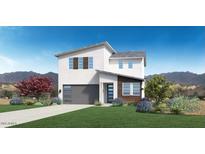 Two-story home with gray garage door and landscaped yard; mountain view in the background at 15426 S 182Nd Ave, Goodyear, AZ 85338
