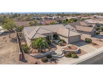 Aerial view of a single-story home with tile roof, desert landscaping, and a two-car garage at 15511 W Agua Linda Ln, Surprise, AZ 85374