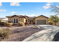Single-story home with a two-car garage and desert landscaping at 20089 N 263Rd Dr, Buckeye, AZ 85396