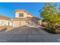 Two-story house with a three-car garage and landscaped front yard at 20435 N 39Th Dr, Glendale, AZ 85308