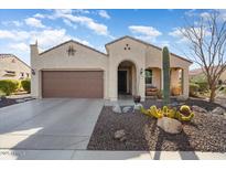 Single-story home with desert landscaping and a two-car garage at 26343 W Tina Ln, Buckeye, AZ 85396