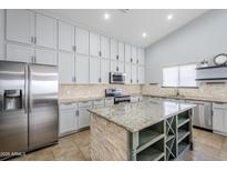 Modern kitchen with stainless steel appliances and granite island at 3121 E Hackamore St, Mesa, AZ 85213