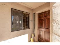 Inviting front door and window adorned with a charming duck, creating a warm welcome to the home at 9270 E Mission Ln # 111, Scottsdale, AZ 85258