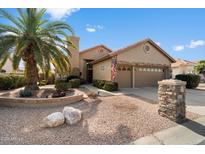 Single-story home with a two-car garage and desert landscaping at 10605 E Nacoma Dr, Sun Lakes, AZ 85248