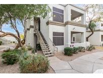 Exterior view of condo building with stairs and landscaping at 11375 E Sahuaro Dr # 2066, Scottsdale, AZ 85259