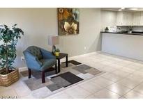 Bright living room features tile floors and a comfy chair at 1432 W Emerald Ave # 51, Mesa, AZ 85202